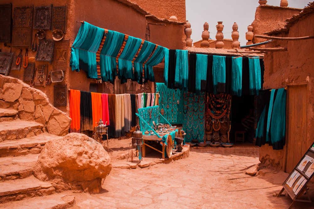 A souk stall in Marrakech draped with teal and orange textiles