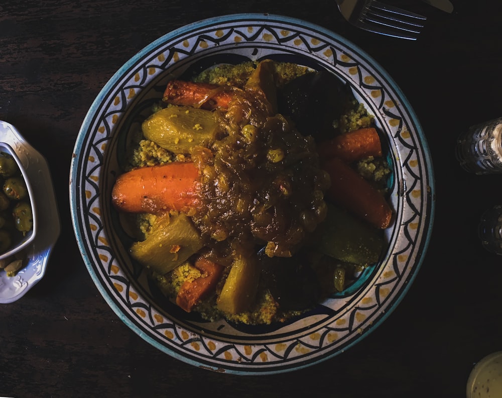 A Moroccan tagine of vegetables and couscous in a painted dish